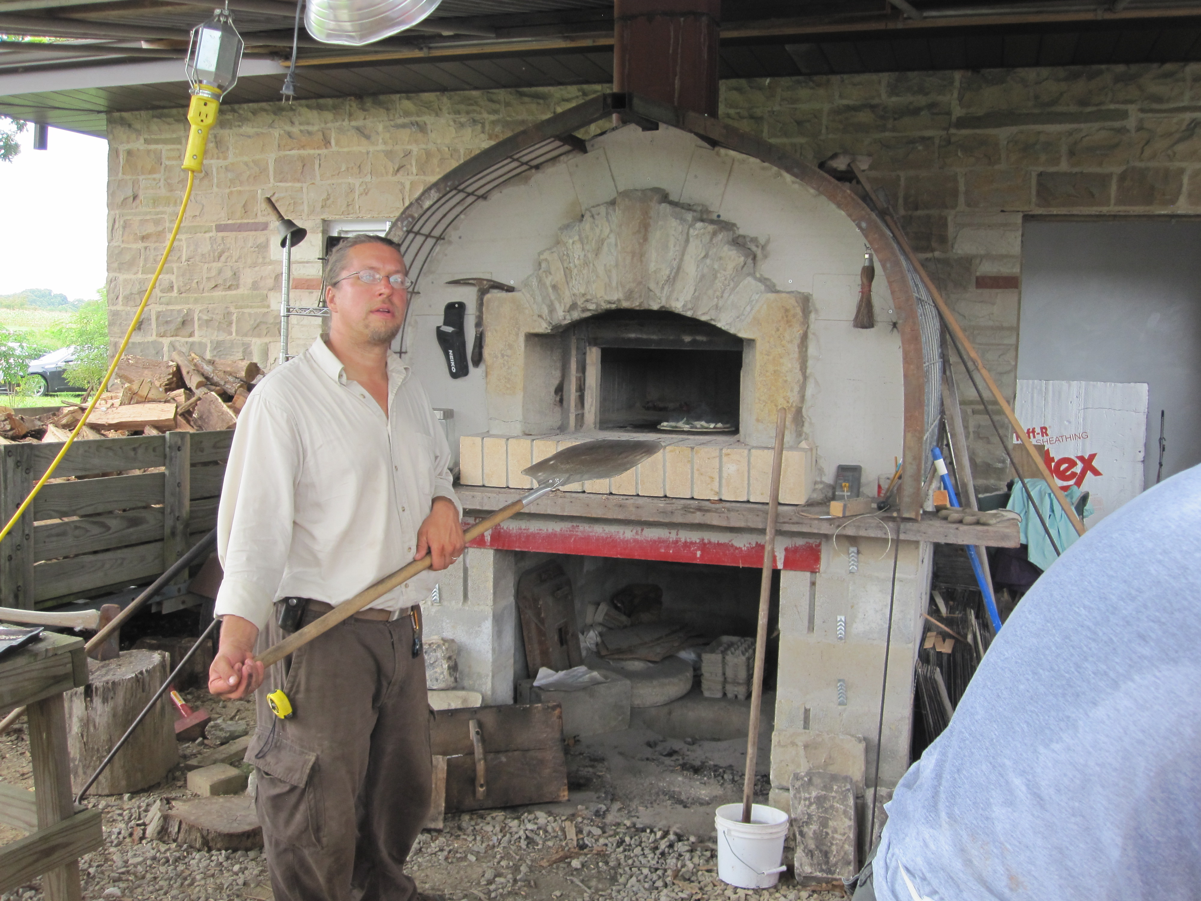 Greg Boulos Cooking Pizzas In the Wood Fire Pizza Oven