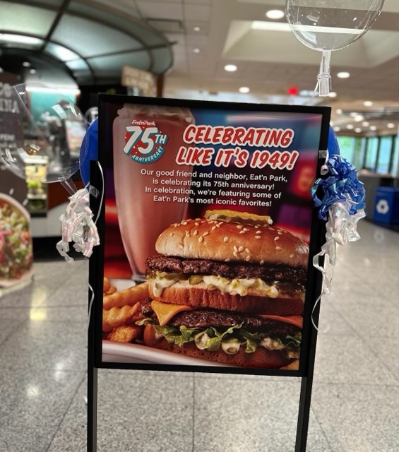 a photo of a standee with a burger and the message "Celebrating like it's 1949!"