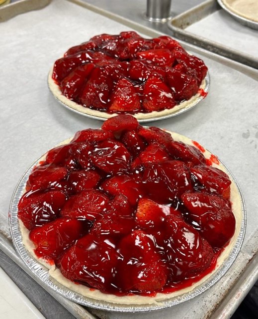 two strawberry pies on a tray