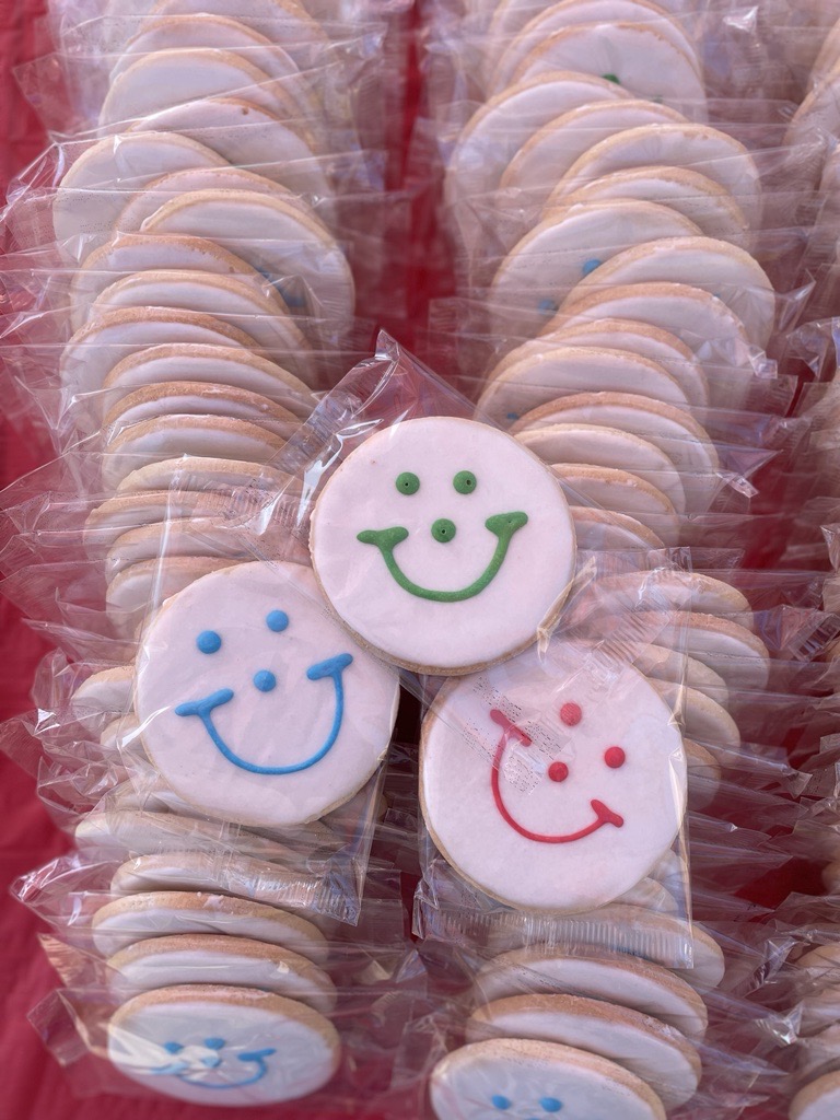 rows of Smiley Cookies, or cookies with blue, red, and green smiles