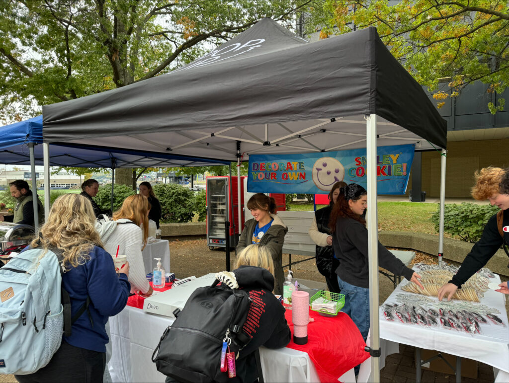 a tent with people decorating Smiley Cookies