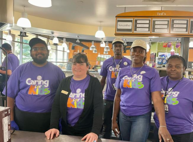 team members wearing purple Caring for Kids shirts