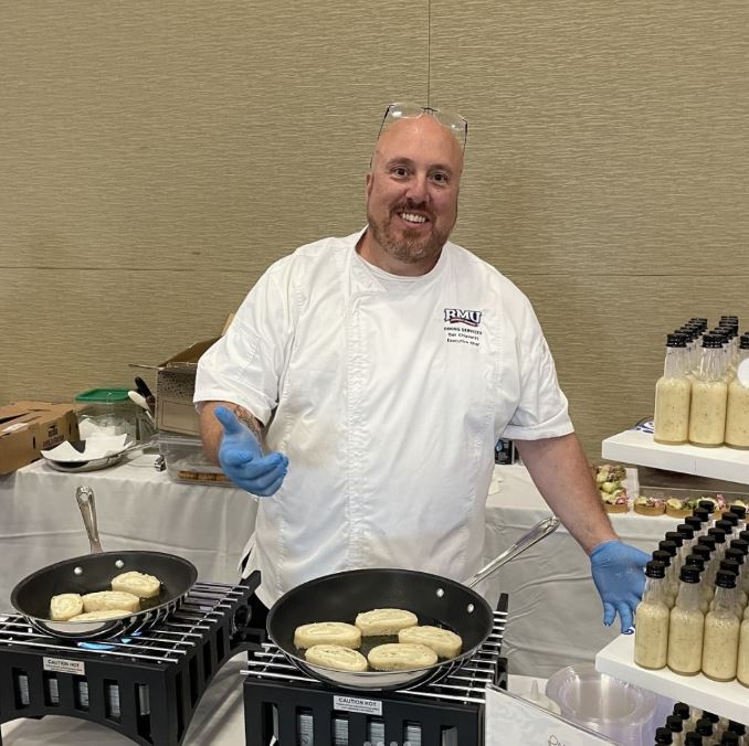 a chef presenting at his food station