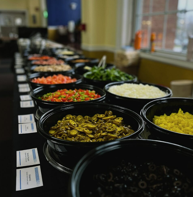 a series of pizza toppings on a table