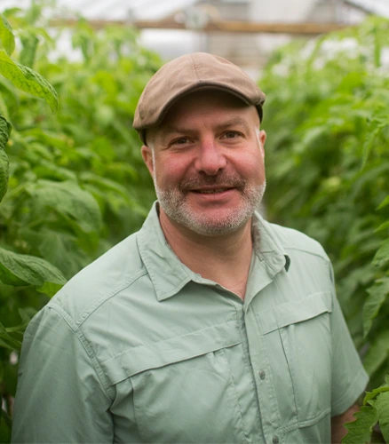 A Parkhurst partner stands proud within his farmed goods.
