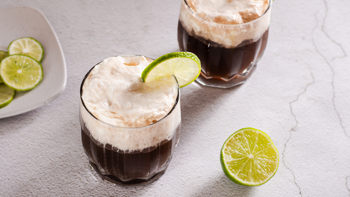 two dirty soda drinks with whipped topping on top