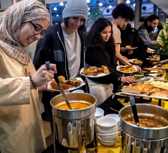 Students of diverse culture prepare their plates at a buffet of various of Parkhurst food.