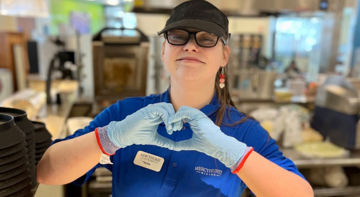 A Parkhurst team member shows her love for her career by making a heart with her hands.