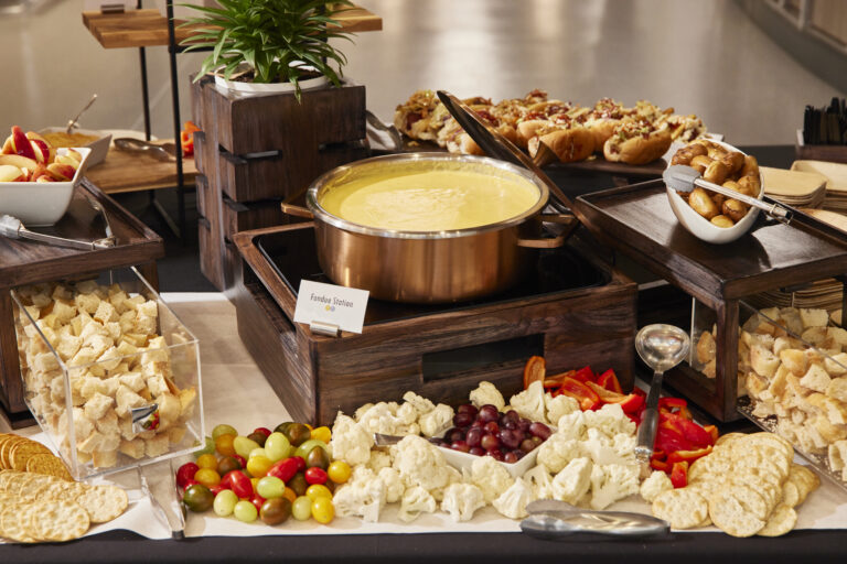 a spread of cheese with fondue at the center