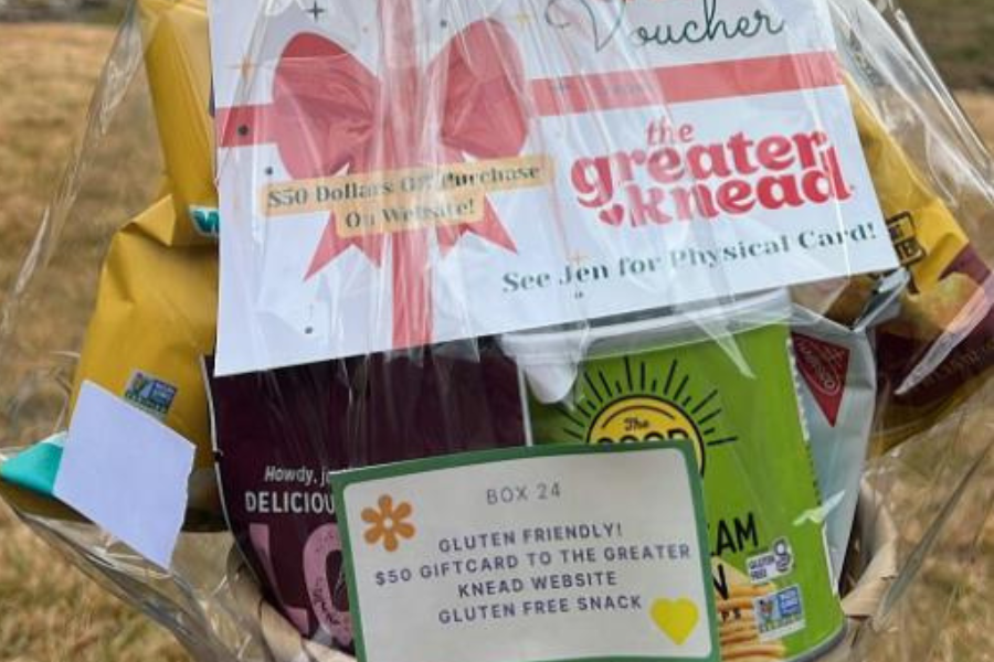 a raffle basket outside filled with coupons and cooking utensils