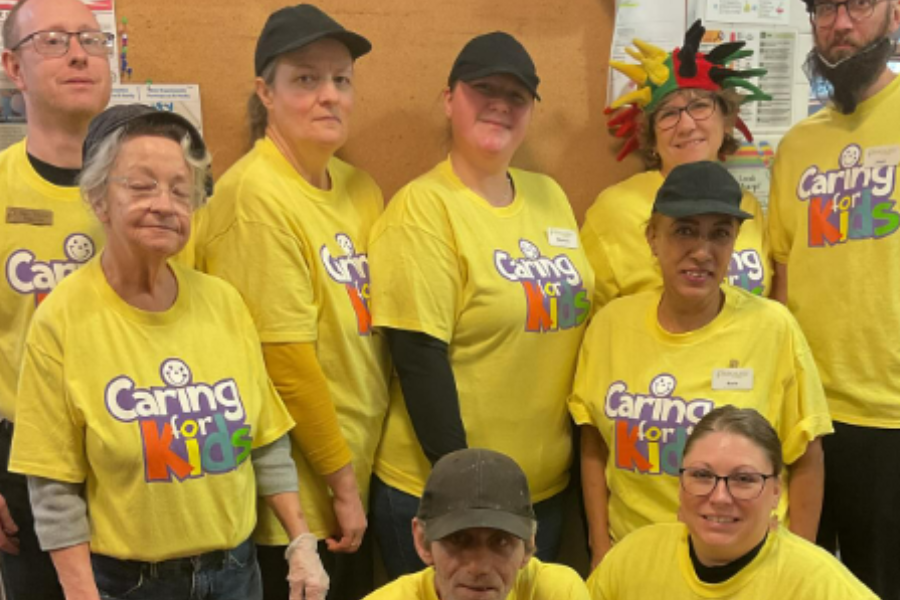 Parkhurst team members pose in their yellow Caring for Kids shirts
