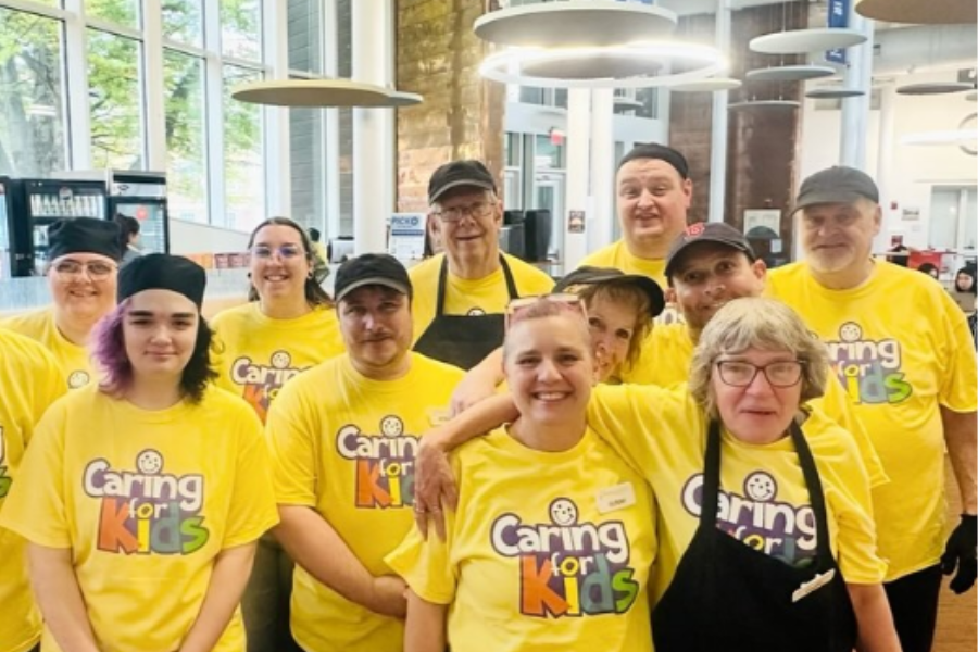 Colby Dining team members in yellow shirts for Caring for Kids