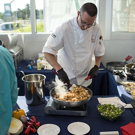 A Parkhurst chef cooks a delicious and innovative meal in a hot pan.