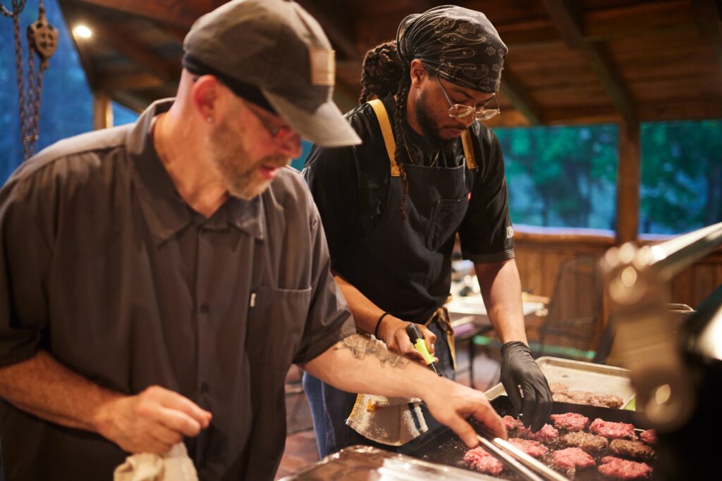Parkhurst chefs grilling burgers at camp'n cook event.