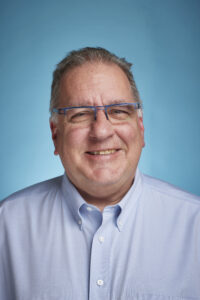 Man smiling with blue background