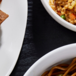 Spread of menu items - egg rolls, noodles
