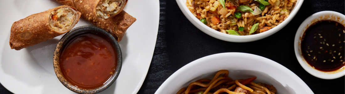 Spread of menu items - egg rolls, noodles