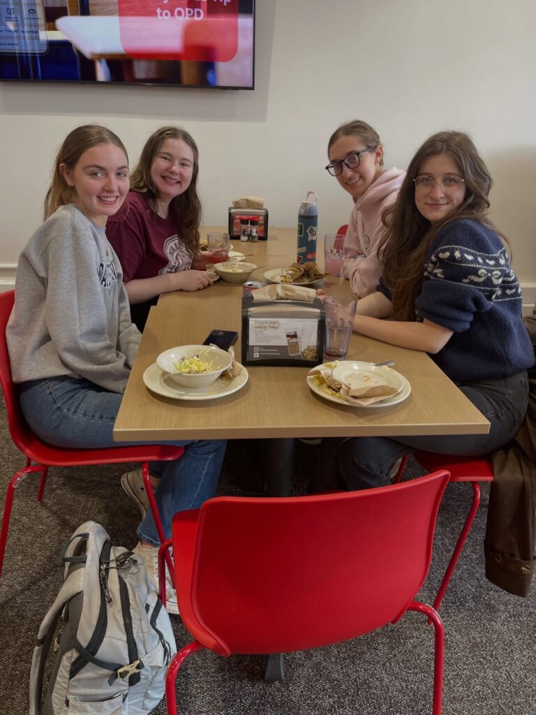 students celebrate Pride Month at Otterbein at a table with food
