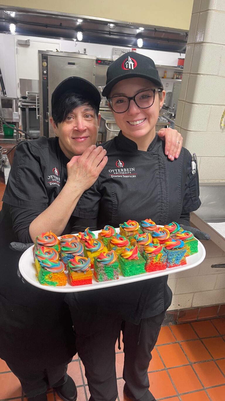 Parkhurst team members hold rainbow cupcakes to celebrate Pride Month
