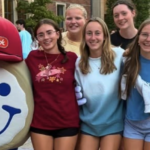 Group of Students with their arms around each other and the Eat'n Park Smiley Cookie