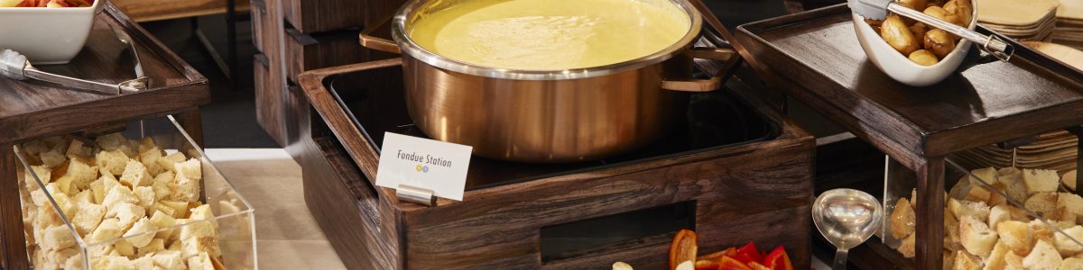 a spread of cheese with fondue at the center