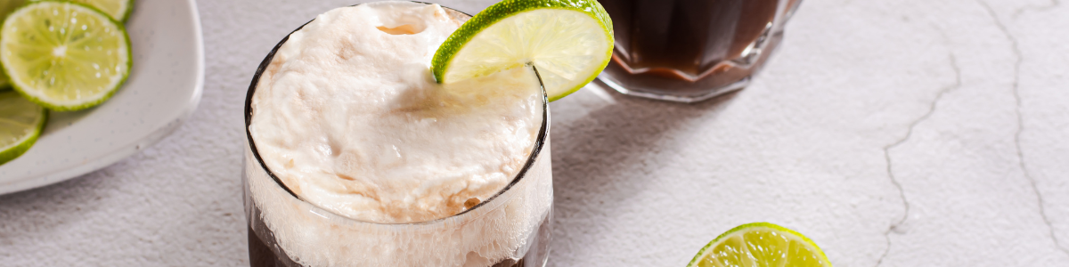 two dirty soda drinks with whipped topping on top